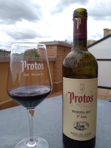 A bottle of Protos wine with glass